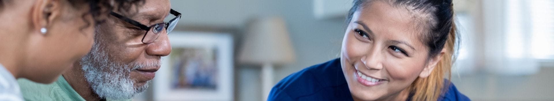 Nurse with adult patients smiling