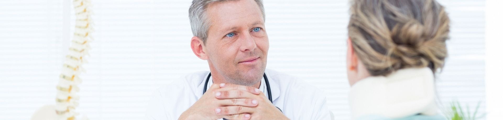 Doctor talking to patient with neck brace
