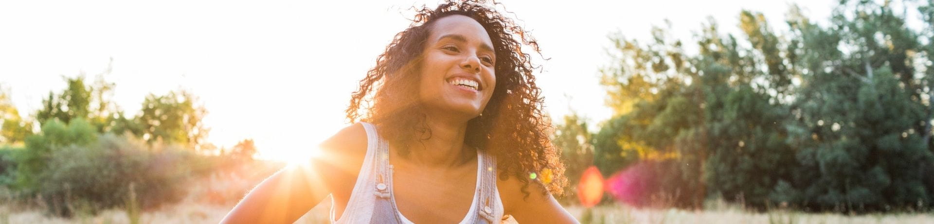 Young adult woman smiling in field