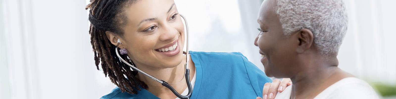 "nurse listening to patients heart"
